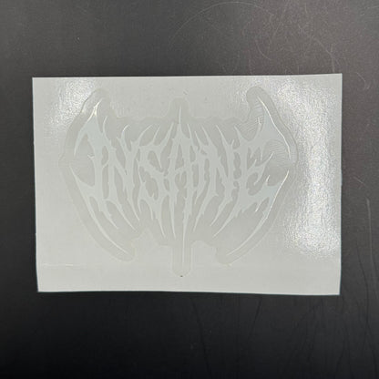 White rectangular sheet with a cut-out design on a dark surface